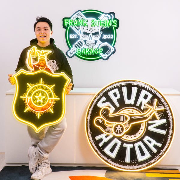 Spur Motors and security badge signs side by side