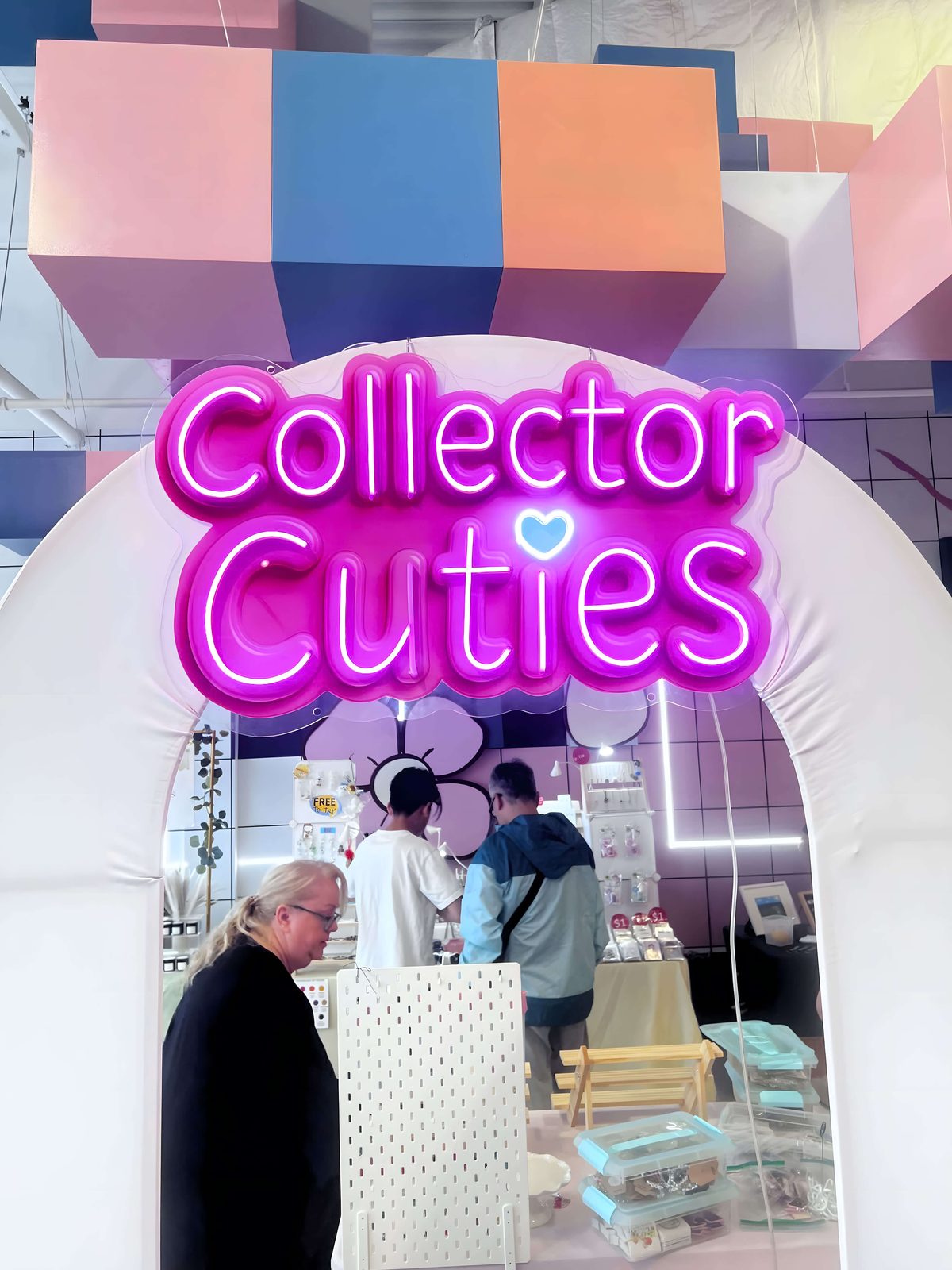 Collector Cuties logo sign above a retail booth