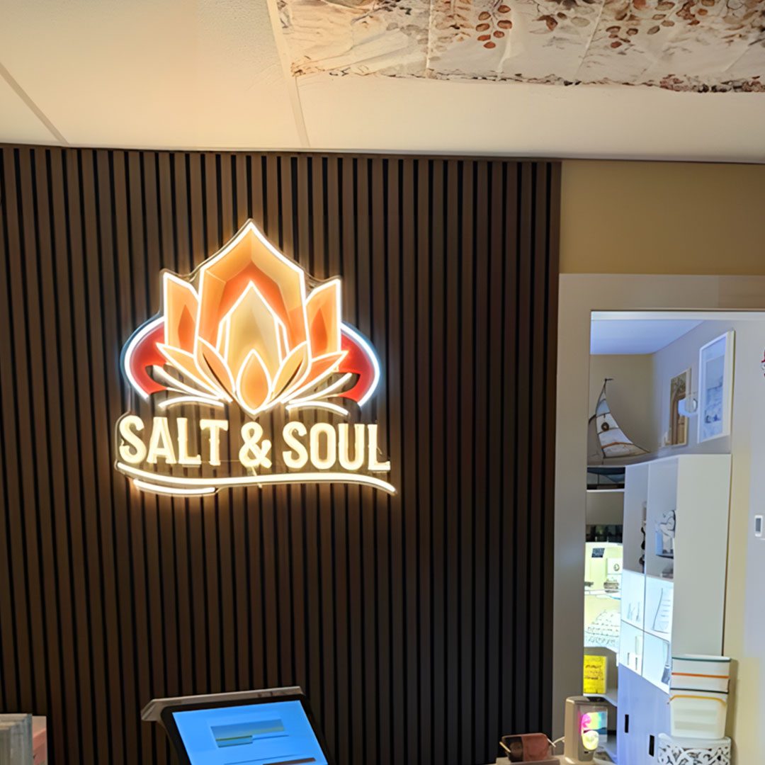 Salt & Soul restaurant logo sign on a slatted wood wall