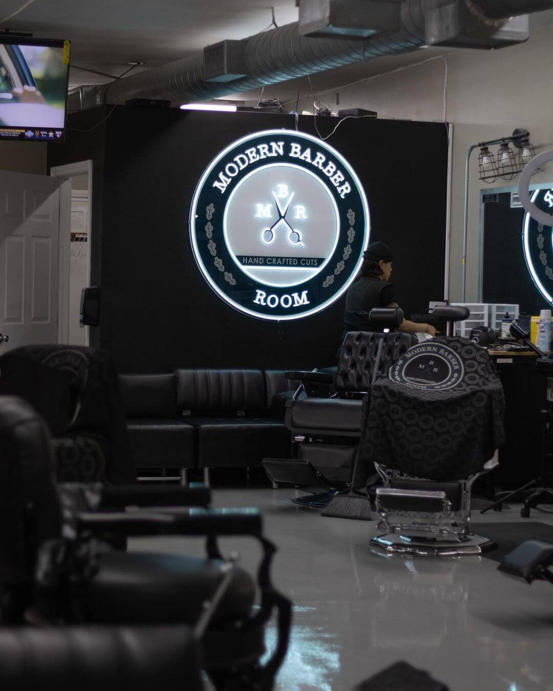 Barber shop crest sign on a dark salon wall