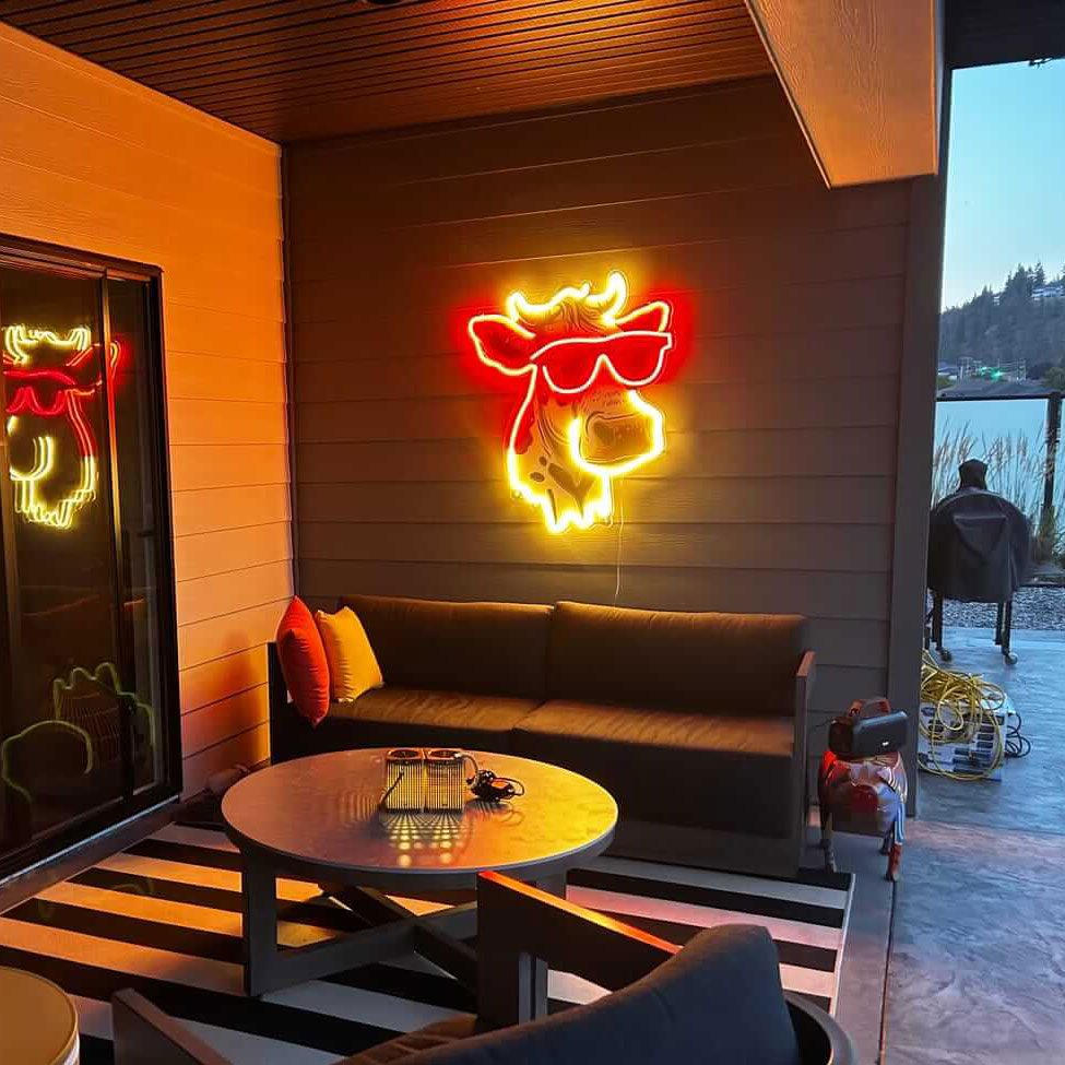 Glasses logo sign glowing above a restaurant booth
